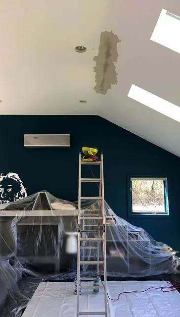Deep teal under the skylights — Ceiling line and protected floor